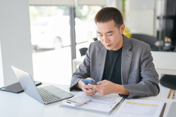 Fototapeta premium Asian Business man working with laptop. Young business man thinking Concentrated at work.