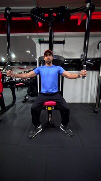 Front View of Athlete Performing Pec Deck Chest Fly &ndash; Vertical Chest Workout