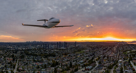 Small Plane Glides Over Burnaby at Sunset, Cityscape and Mountains in Golden Hour Light