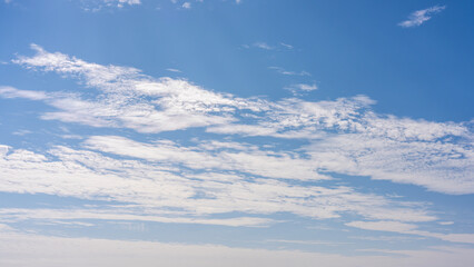 Fototapeta premium Clear Blue Sky with Fluffy White Clouds