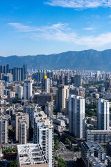 Fototapeta premium Urban Skyline with Modern Skyscrapers and Mountains