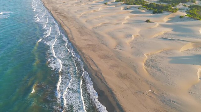 Gelemis, Turkey. Close aerial view of white foam waves on Patara Beach shoreline, blue mediterranean water and wet sand in morning light. Aerial View, MasterShots, Rocket
