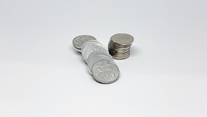 Loose money coins on white background illustrating financial planning