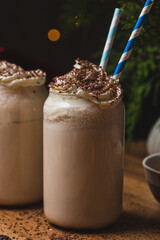 Glasses of butterbeer with a cap of whipped cream
