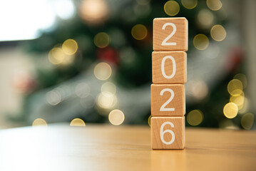 Craft wooden cube blocks 2026 with defocused light background. Numbers on wooden blocks with copy space. 2026 happy new year idea concept.
