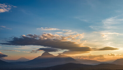 Mountain range with cloud formations during sunset or sunrise.