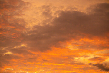 Dramatic twilight sky, the beauty of slightly overcast orange clouds.