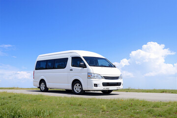 White Passenger Van on Countryside Road Under Blue Sky