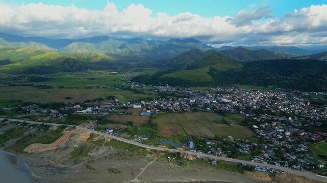 A spinning wide aerial reveals Bontoc town nestled in the valley with mountain ranges encircling the horizon Bontoc, Nueva Vizcaya, Philippines