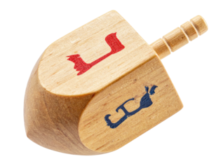 Wooden dreidel with painted Hebrew letters, ready to spin