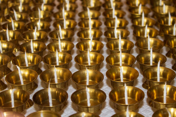 Buddhist Altar Candles at Religious 108 Butter Lamp Festival in Temple Monastery. Pouring Melted Butter Oil. Preparation process