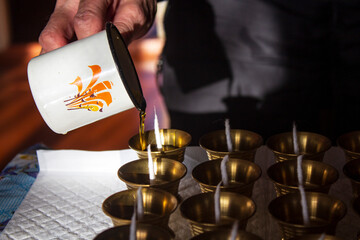 Buddhist Altar Candles at Religious 108 Butter Lamp Festival in Temple Monastery. Pouring Melted Butter Oil. Preparation process