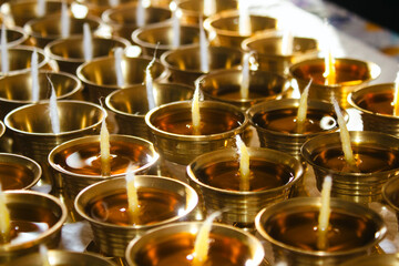 Buddhist Altar Candles at Religious 108 Butter Lamp Festival in Temple Monastery. Pouring Melted Butter Oil. Preparation process