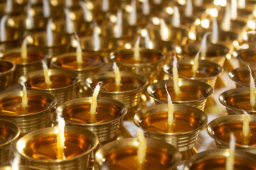Buddhist Altar Candles at Religious 108 Butter Lamp Festival in Temple Monastery. Pouring Melted Butter Oil. Preparation process