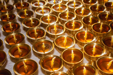 Buddhist Altar Candles at Religious 108 Butter Lamp Festival in Temple Monastery. Pouring Melted Butter Oil. Preparation process