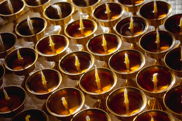 Buddhist Altar Candles at Religious 108 Butter Lamp Festival in Temple Monastery. Pouring Melted Butter Oil. Preparation process