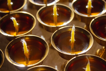 Buddhist Altar Candles at Religious 108 Butter Lamp Festival in Temple Monastery. Pouring Melted Butter Oil. Preparation process