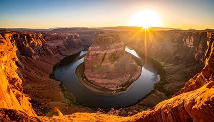 A scenic canyon, river bends in a horseshoe shape, lit by a vibrant sunrise