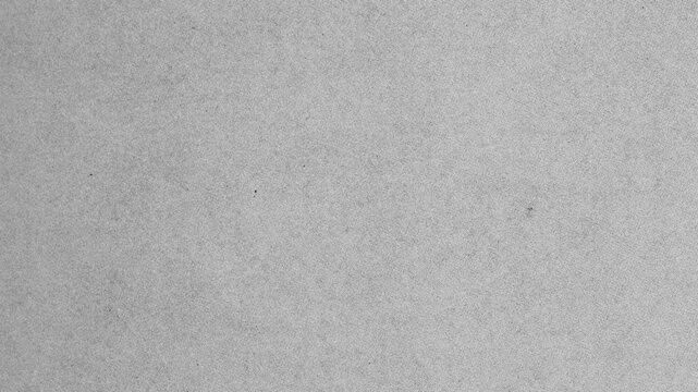 Abstract grey grunge paper texture background for overlay.Close up of white grainy surface suitable for background, wallpaper, or vintage film noise effect.