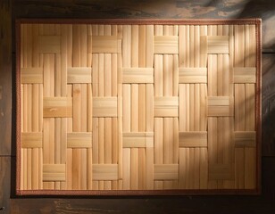 A rectangular, woven placemat, made of bamboo or similar wood, sits on a darker surface