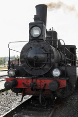 Fototapeta premium A historic steam locomotive faces the camera on a railway track
