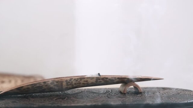 Incense burning. Spiritual practice. Meditation activity yoga therapy mental calming aromatherapy destress tool smoldering fume.