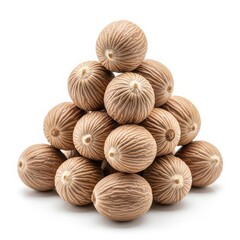 Pile of nutmeg seeds on white background