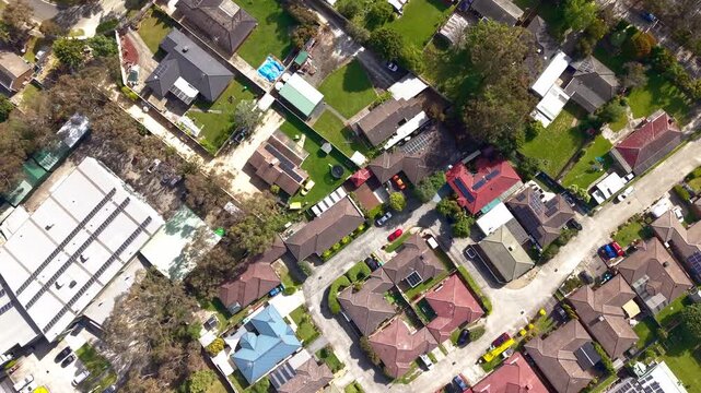 Drone video capturing vibrant rooftops and green yards in a sunny Melbourne suburb. Aerial footage highlights residential layout, diverse architecture, and urban planning.
