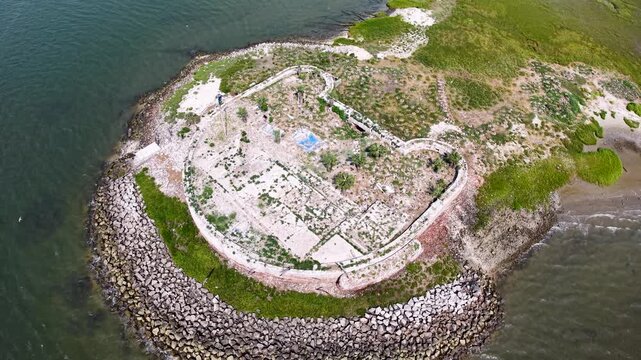 Aerial view of Castle Pinckney on Shutes Folly Island, surrounded by the Charleston Harbor waters