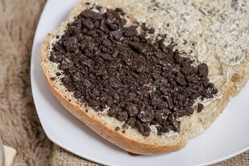 Bread with chocolate cookies oreo cheese and butter spread on a plate for breakfast	
