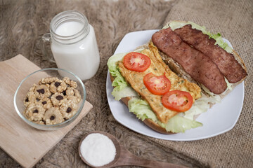 Big breakfast, bread, chicken slice, tomato, lettuce, smoked beef, egg, salad with milk. Bread sandwich fresh and healthy food meal lunch dinner breakfast slices of sandwiches.