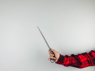 Hand holding a saw against a plain background, showcasing tool details, grip texture, and lighting for DIY, home improvement, and construction themes.