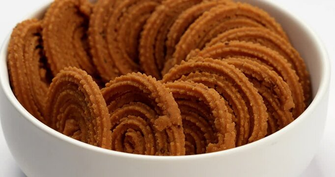 Chakli is a savoury snack from India. It is a spiral shaped snack with a spiked surface
