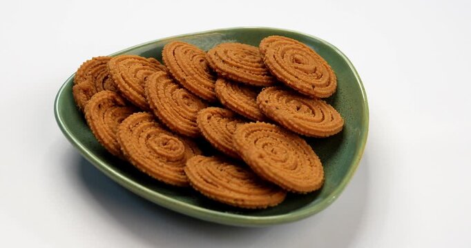 Chakli is a savoury snack from India. It is a spiral shaped snack with a spiked surface