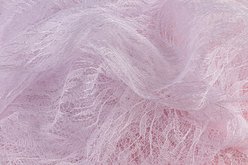 Elegant beautiful waves of transparent guipure fabric in white with a floral pattern. airy fabric material. Wedding concept. tulle.