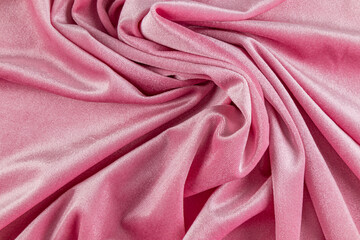 Elegant background of soft folds of velvet pink fabric. beautiful pattern of textile folds. layout for design. drapery.