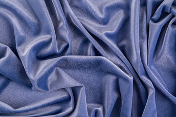 Beautiful abstract velvet fabric background in blue or ink color. soft folds of textiles. top view. drapery. layout for design.