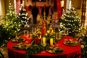 Elegant decor for Christmas family dinner. Center piece vintage chandelier with candles.
