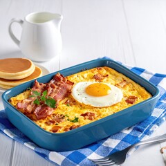 Baked breakfast casserole with bacon, egg, and pancakes