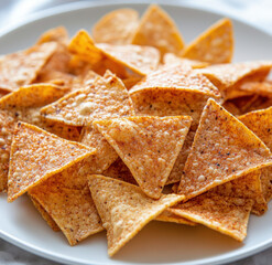 Protein Tortilla Chips With Light Seasoning Served On White Plate
