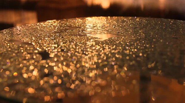 Glass table on rainy Paris street with warm evening light and romantic mood