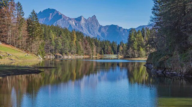 Time lapse, lake surrounded by the mountains. Lake Chapfensee, Hydroelectric reservoir high in the mountains. Mels, Canton of St. Gallen, Switzerland.