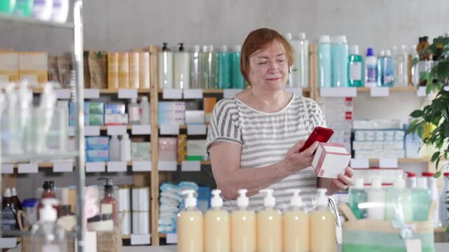 Senior woman in pharmacy scans QR code on tablet pills and uses link to go to manufacturers website. Dietary supplements, replenishment of vitamin and microelement deficiencies.
