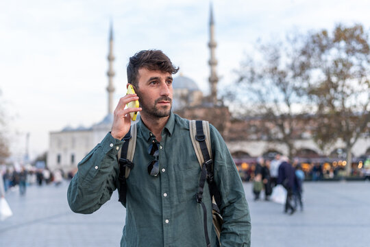 Male traveler calling with smartphone in Istanbul square