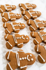 Decorating Gingerbread Man Cookies with Royal Icing for Festive Occasions