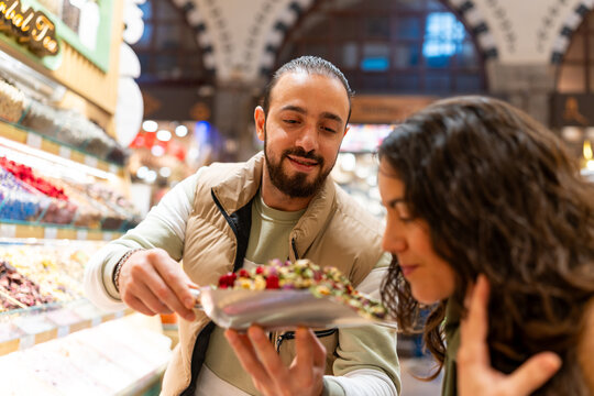 Tourists exploring grand bazaar smelling traditional turkish tea