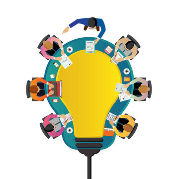 Team Collaboration: An overhead perspective of a team brainstorming, gathered around a central idea, embodying the essence of collaborative innovation and creative synergy.