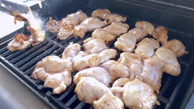 Juicy Chicken Thighs Being Grilled to Perfection on a Small Weber Grill