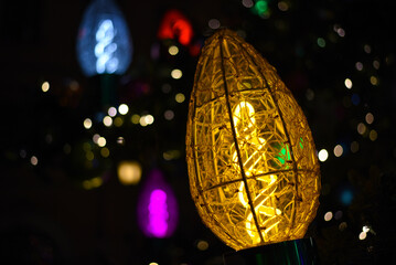 The garland lights glow on the Christmas tree
