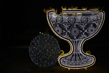 A New Year's glass decorated with garlands of lights. Christmas decor with sparkling garlands.